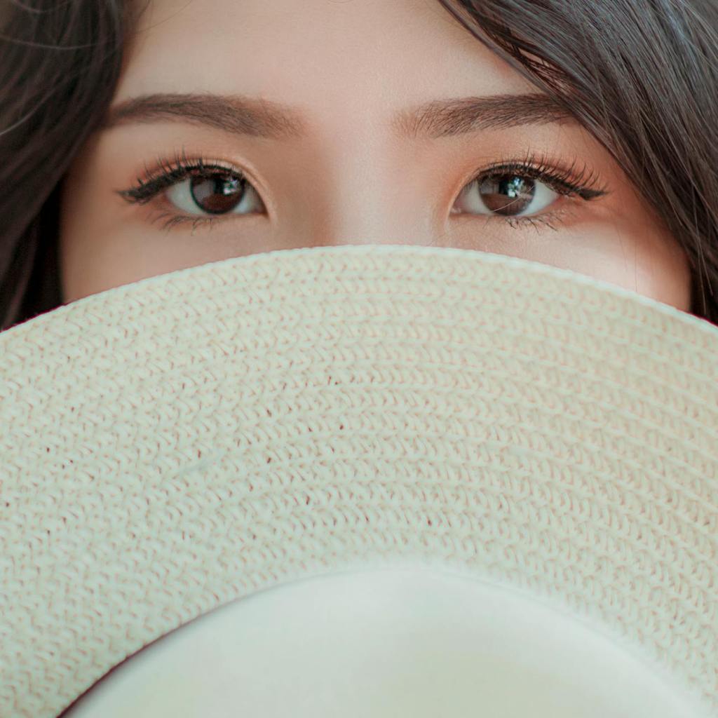 person covering face with hat photo