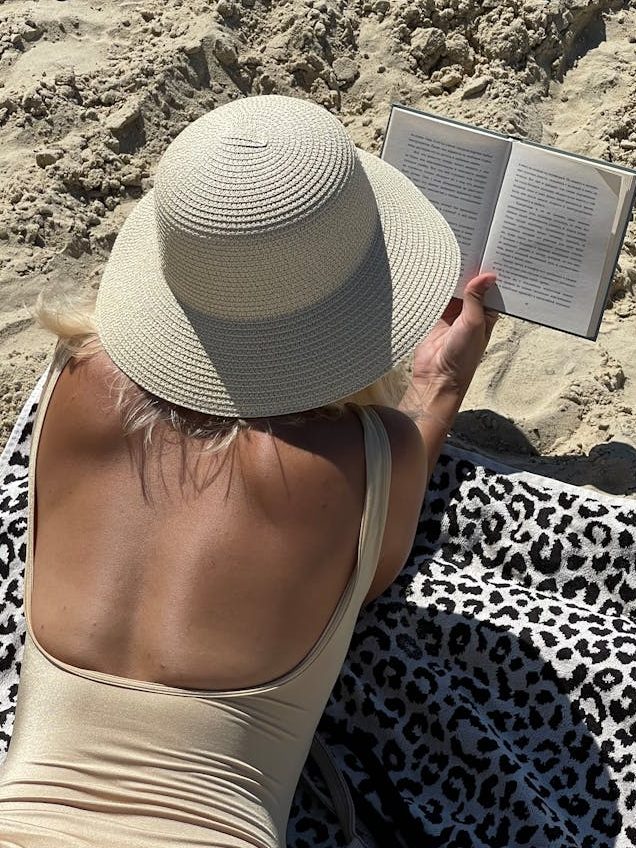 woman in swimsuit reading a book