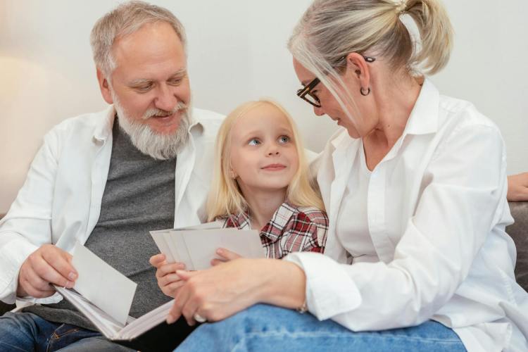 cute girl sitting in between her grandparents