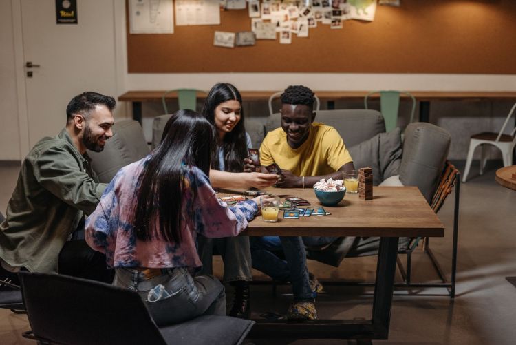 group of friend playing card games