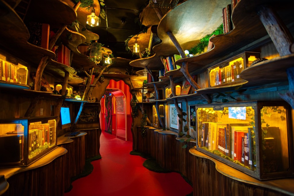 A whimsical library interior with curved wooden shelves filled with books, illuminated by warm lights, creating a cozy, enchanted atmosphere.